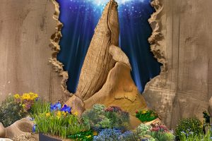 Firefly_Ein Wal als Sandskulptur, größer als die blummen und klein ringsrum blaue Orchideen Kopie 2